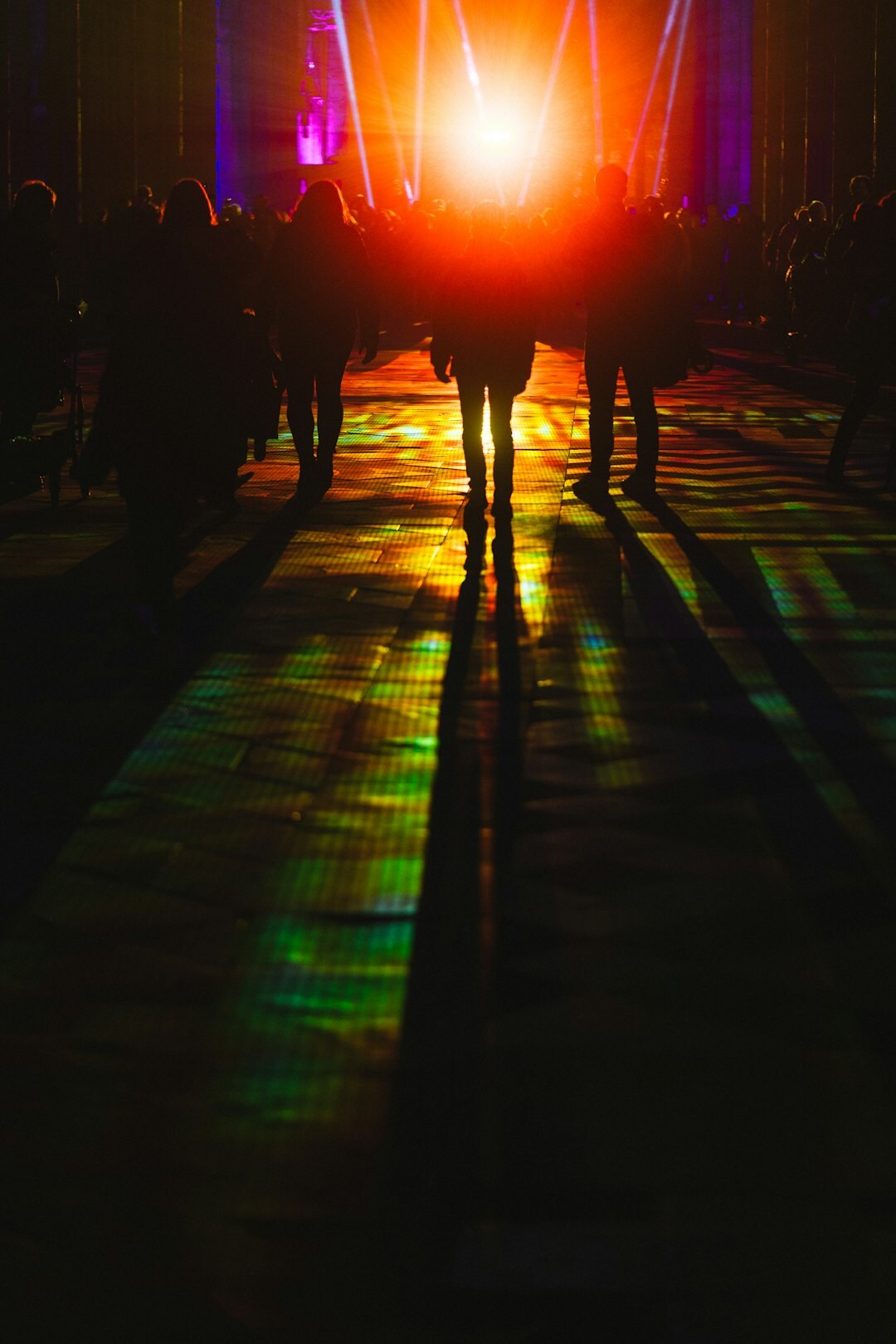Fashion runway show with models walking under stage lights
