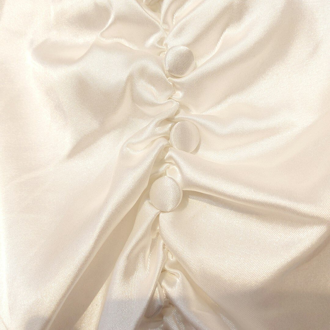 Close up of elegant fabric texture and gold button